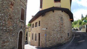 A stone building with a yellow upper section and a stone facade.