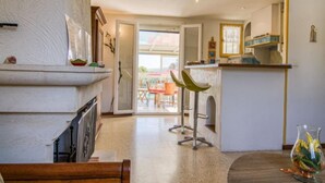 A modern kitchen with a dining area, a bar, and a view of the outdoors. - Les Hauts de Palayson by Interhome (Le Muy)
