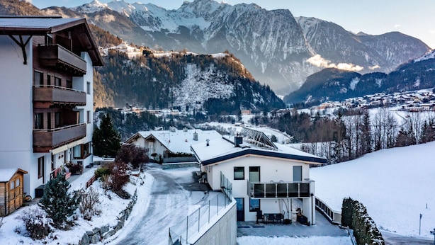 A modern building with a balcony, a snow-covered landscape, and mountains in the background. - Bichleregg by Interhome (Ötz)