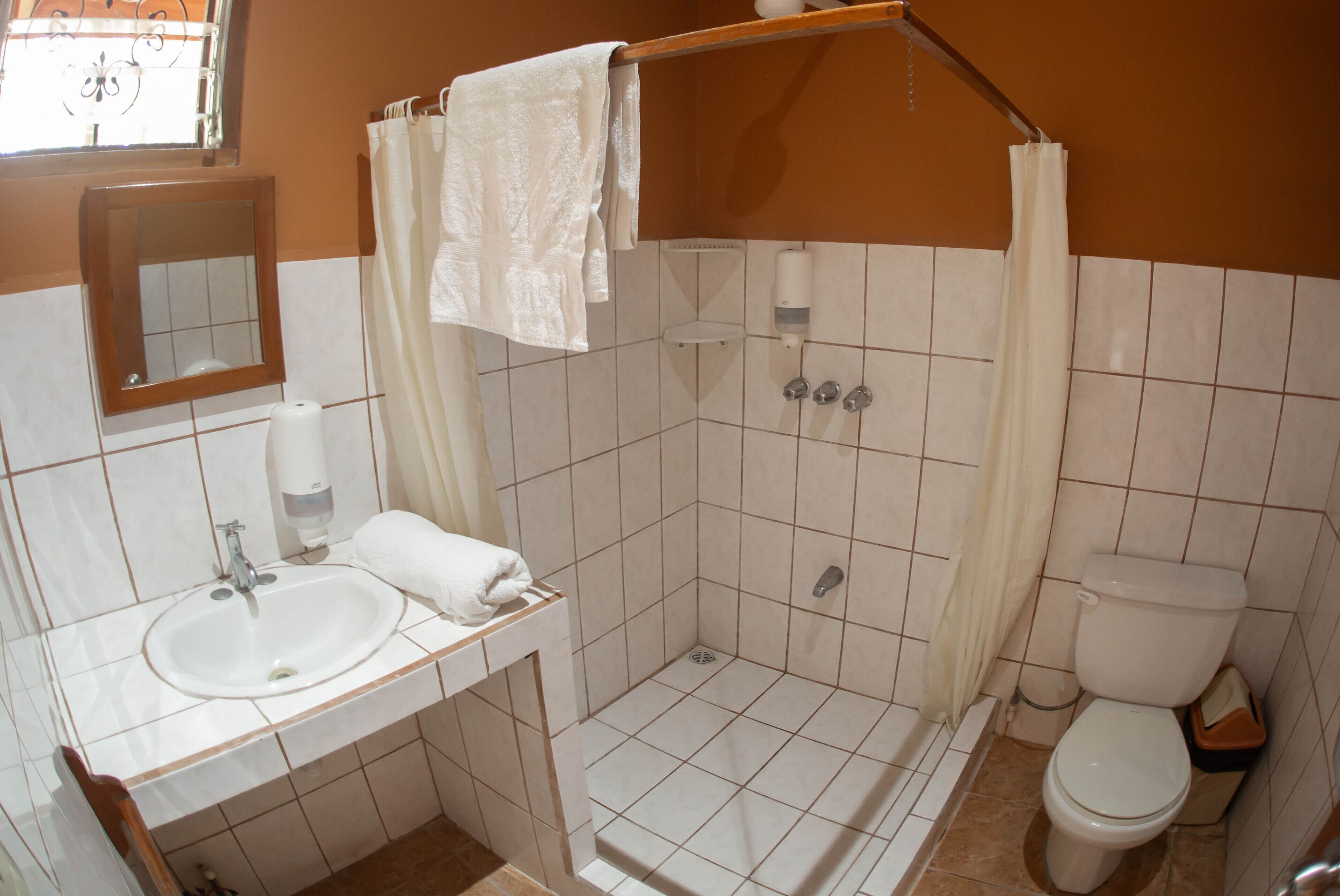 family cabin, private bathroom, poolside | bathroom | shower, rainfall showerhead, hair dryer, towels