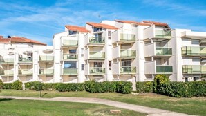 A modern multi-story residential building with balconies and a clear sky. - Les Goelettes by Interhome (Saint Cyprien)