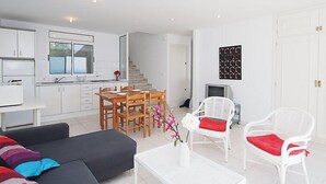 A modern apartment with a dining area, kitchen, and living room. - Prudenci by Interhome (Roses)