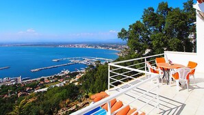 A terrace with a view of a coastal town, including a marina and buildings. - Prudenci by Interhome (Roses)