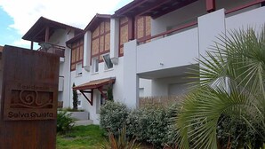 Un edificio residencial con un portón de madera que dice 'Residence Selva Quieta'.