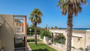A residential area with a two-story building, a small garden, and palm trees. - Les Flots Cypriano by Interhome (Saint Cyprien)