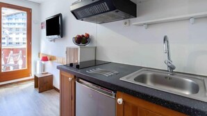 A modern kitchen with a stainless steel sink, a microwave, and a built-in oven. - Chalet Club (Val Claret) by Interhome (Tignes)