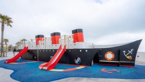 A play area designed like a ship with slides and a lifebuoy symbol. - Copacabana by Interhome (Canet-Plage)