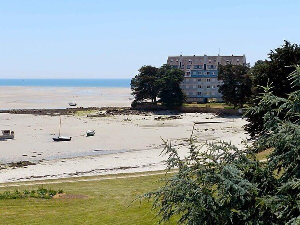 A beach with a building in the background.