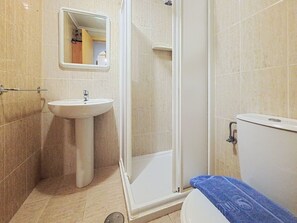 A bathroom with a sink, mirror, shower, and toilet. - Residencial Daly by Interhome (Dénia)