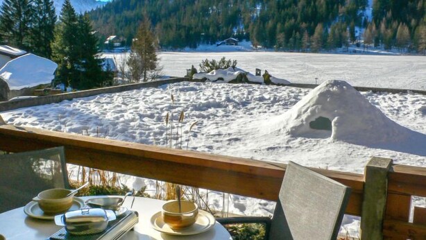 A dining area with a view of a snowy landscape and mountains. - Parc C013 by Interhome (Champex)
