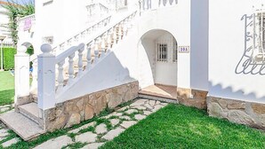 A white building with a stone staircase leading to a balcony. - Club Sevilla I by Interhome (Oliva)
