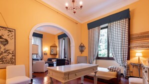 A room with a billiards table, a sofa, and a chair. There is a window with curtains and a lamp on a side table. - Bagnolo by Interhome (Albisola)