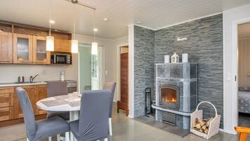 A modern kitchen with wooden cabinets, a microwave, and pendant lights.