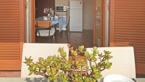 A view of a kitchen with a microwave, refrigerator, and dining table with chairs. - Marcella by Interhome (Forte dei Marmi)