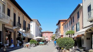A narrow street lined with buildings, some with balconies and outdoor seating, suggesting a pedestrian-friendly area. - Marcella by Interhome (Forte dei Marmi)
