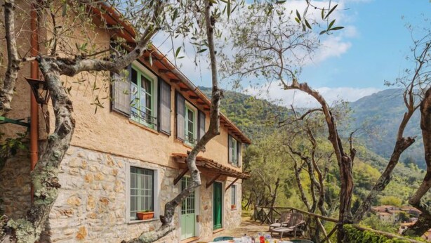 A stone building with a balcony, outdoor dining area, and a view of the surrounding hills. - La Capannella by Interhome (Camaiore)