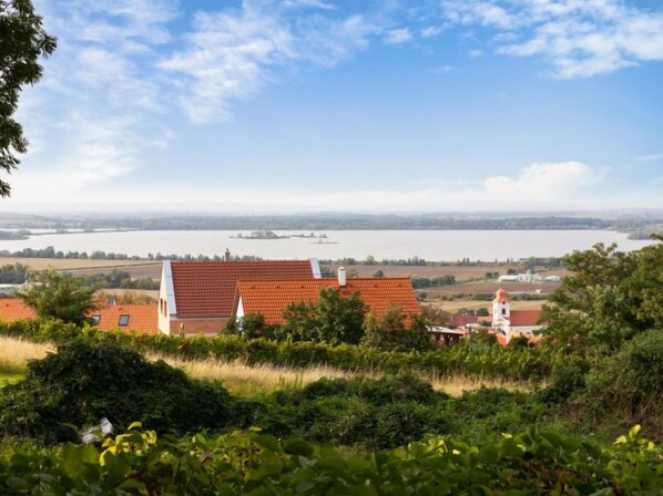 A rural landscape with houses and a large body of water in the background. - Horní Věstonice by Interhome (Horni Vestonice)