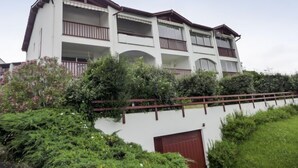 A multi-story building with balconies, a white facade, and a red roof. - Hego Alde by Interhome (Bidart)