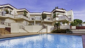 A modern building with a swimming pool, balconies, and a staircase leading to the upper floors. - Mar Nou by Interhome (Llançà)
