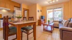 A modern apartment with a dining area, kitchen, and living room. - Res Mediterraneo by Interhome (Deltebre)