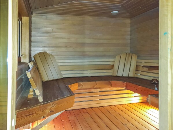A sauna with wooden walls and benches.