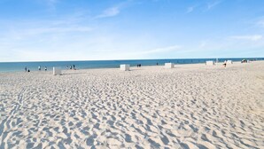 A wide sandy beach with a clear blue sky. - Sunrise Views at Emerald Key 201 – Gulf Views! (Orange Beach)