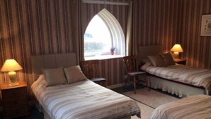 A hotel room with two single beds, a small table, a chair, and a window with curtains. - Wester Riechip by Interhome (Dunkeld)