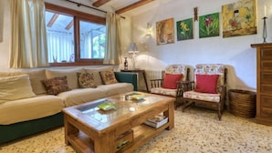 A cozy living room with a sofa, two armchairs, a coffee table, and artwork on the walls. - Florencia by Interhome (Jávea)