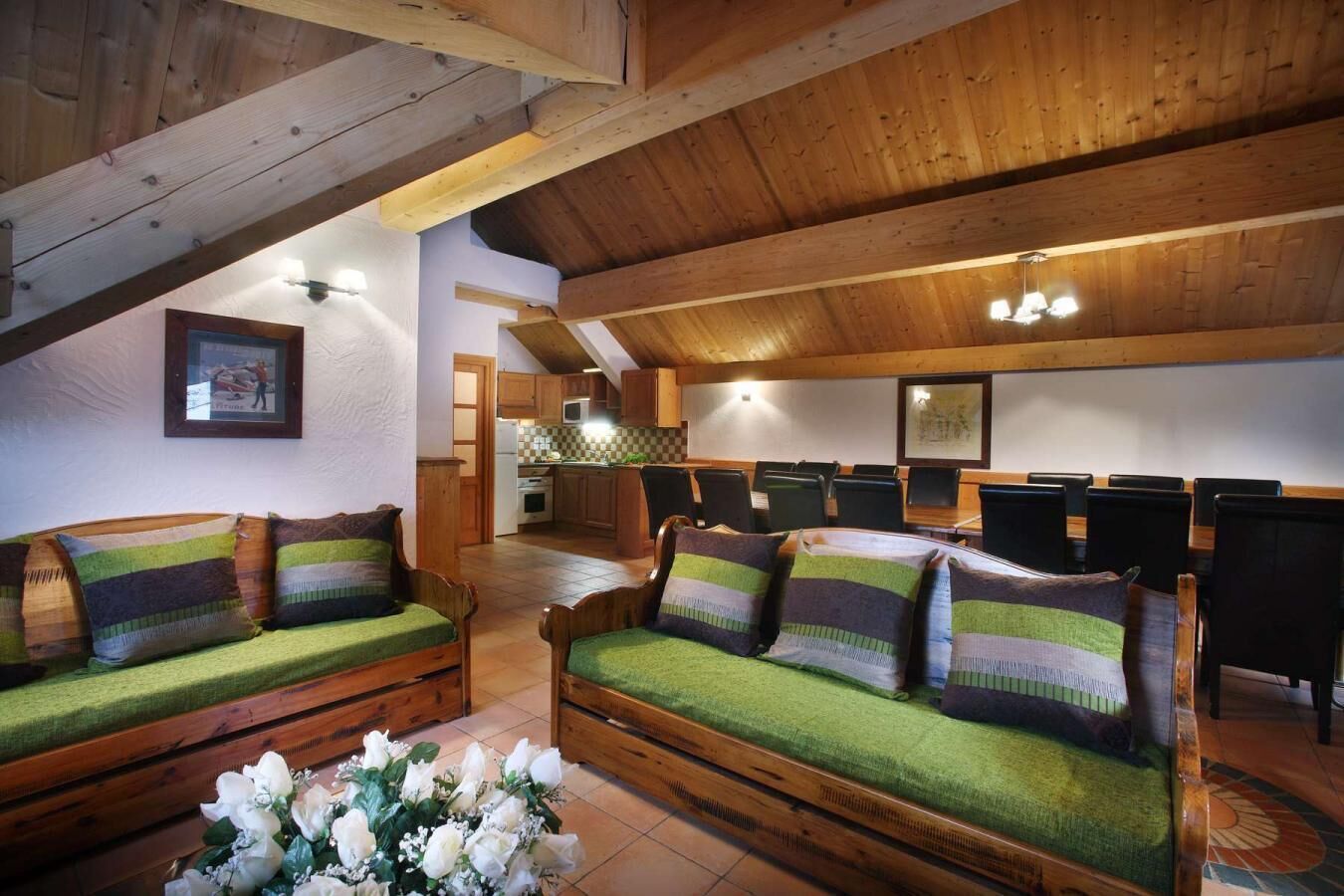 A cozy room with wooden furniture, a dining area, and a kitchen.