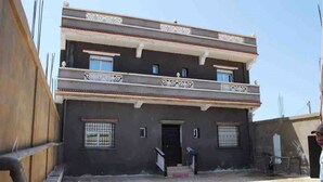 A two-story building with a balcony, a door, and a window. - Apartment 3 combining countryside and sea (Hadjadj)