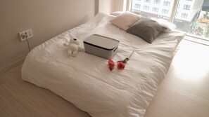 Relax in a cozy retreat with a comfortable bed, complete with a plush comforter and pillows.