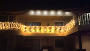 A building with a balcony decorated with string lights. - Nice newly renovated apartment in a quiet location !! (Wald)
