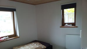 A small, single-bed room with a window, a radiator, and a door. - Nice newly renovated apartment in a quiet location !! (Wald)