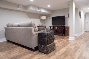 Relax in this stylish living room with a comfortable sofa, flat-screen TV, and entertainment center.