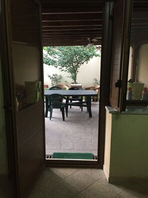 Step outside to a patio with a dining table and comfortable seating.