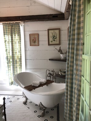Bathtub, towels, soap, toilet paper