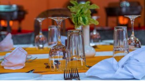A dining table set with clear glassware, a white napkin, and a fork. - Thomson Falls Lodge (Nyahururu)