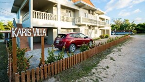 A multi-story building with a sign reading "Karis Villa." - Karis Villa (Saipan)