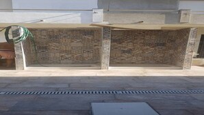 A covered outdoor seating area with patterned tiles and a green hose visible. - Casa Antonella Nice apartment (Capo Rizzuto)
