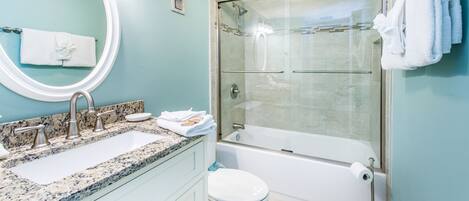 Ein Badezimmer mit Waschbecken, Toilette und einer Duschkabine.