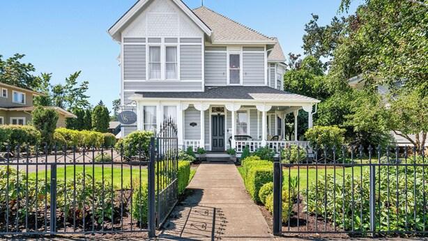 A two-story house with a front porch, a garage, and a well-maintained garden. - Historic Silverton Home 5 BR, 6 Bath.  Ask about 6th & 7th bedroom add-ons. (Silverton)