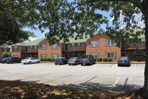 Guests can park their vehicles in the spacious lot adjacent to this multi-story building.