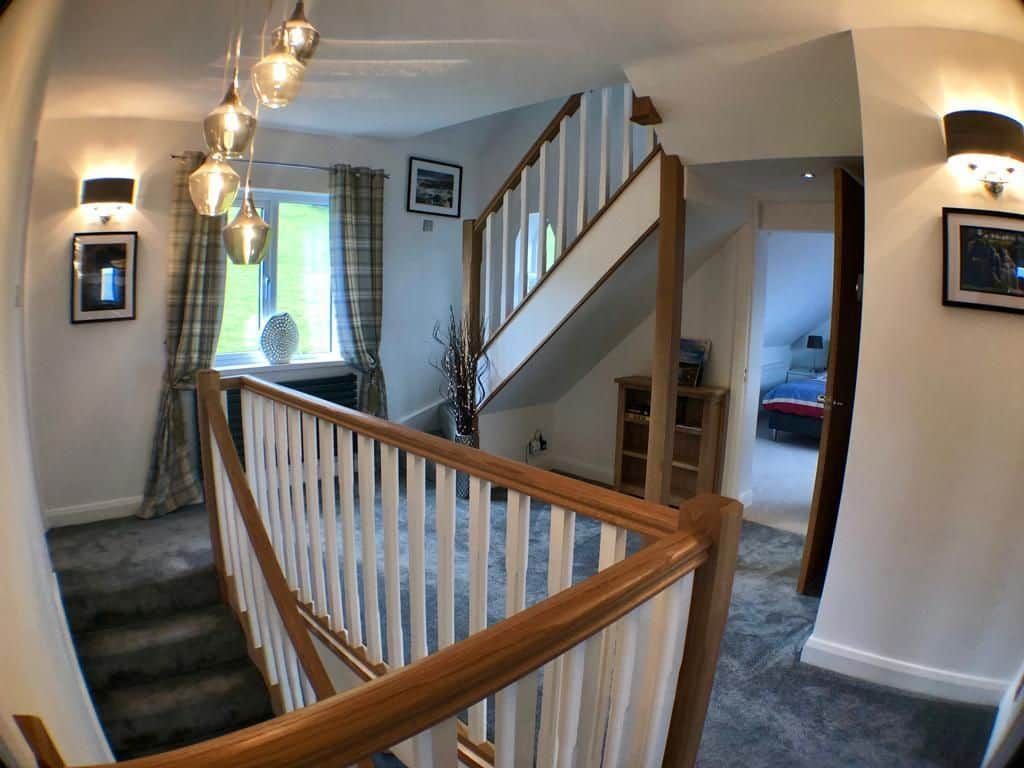 A staircase with wooden railings leading to a second floor.