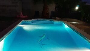 Een zwembad met een dolfijndecoratie in het midden.