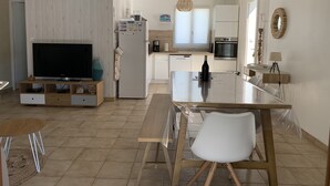 A modern kitchen with a large island, white cabinetry, and a built-in oven. - Renovated house, 300m from the beach, with a boule court (La Brée-les-Bains)