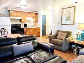 Enjoy a stylish living space with a modern kitchen, dining area, and comfortable seating.