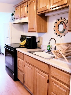 Enjoy cooking in this well-equipped kitchen with an oven, microwave, and stainless steel sink.