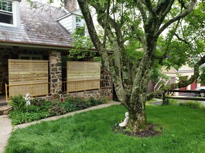 Set amidst a serene landscape, this property offers a tranquil retreat with a garden and a shaded lawn.