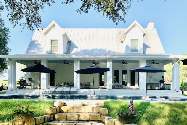 Stately family friendly farmhouse on 10 verdant acres with storybook lake view.