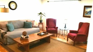 A living room with a sofa, two armchairs, a coffee table, a side table, a lamp, a clock, and a potted plant. - MOTELS ARE GROSS
BEAUTIFUL RANCH STYLE
Approx 145 Nightly

DISCOUNTS AVAILABLE 
 (Columbus)